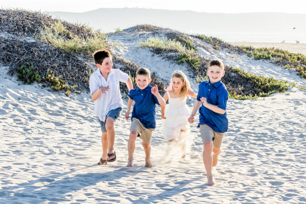 A Windy Evening with a Lifestyle Photographer San Diego Families Trust Family vacation portraits documenting connection and togetherness on Coronado Beach